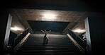 Ballet dancer, night and woman on stairs, training and artistic with performance, light and talent. Person, dancing and girl with workout, culture and practice with routine, freedom and alone