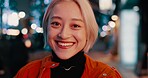 Japanese, city and portrait of happy woman at night in Tokyo with freedom on travel, adventure or journey. Gen z, girl or excited to explore urban town street on vacation or holiday with neon lights