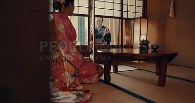 Buy stock photo Japanese, women and kimono in corridor for ceremony in chashitsu room with indigenous fashion or clothing. People, ritual and culture for temae, wellness and zen in architecture building in Tokyo