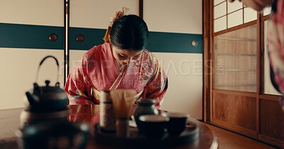 Woman in Japanese tea house with bow, kimono and relax with mindfulness, respect and gratitude. Girl at calm tearoom for matcha drink, zen culture and ritual at table for traditional ceremony in home
