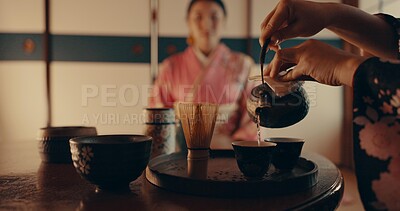 Buy stock photo Woman pouring traditional Japanese tea with kimono, teapot and relax with mindfulness, respect and service. Girl at calm tearoom with matcha drink in cup, zen culture and ritual at table for ceremony