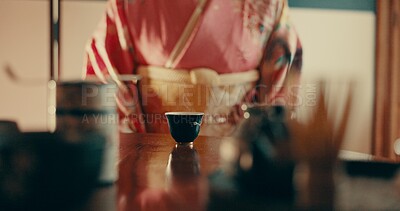 Woman with traditional Japanese tea cup on table, kimono and relax with mindfulness, respect and process. Girl at calm tearoom with matcha drink, Asian zen culture and social ritual ceremony in home.