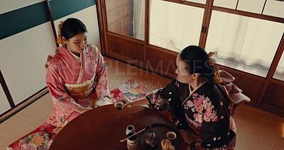 Women with traditional Japanese tea cup, kimono and relax with mindfulness, respect and conversation. Friends at calm tearoom with matcha drink, Asian zen culture and ritual at table for ceremony.