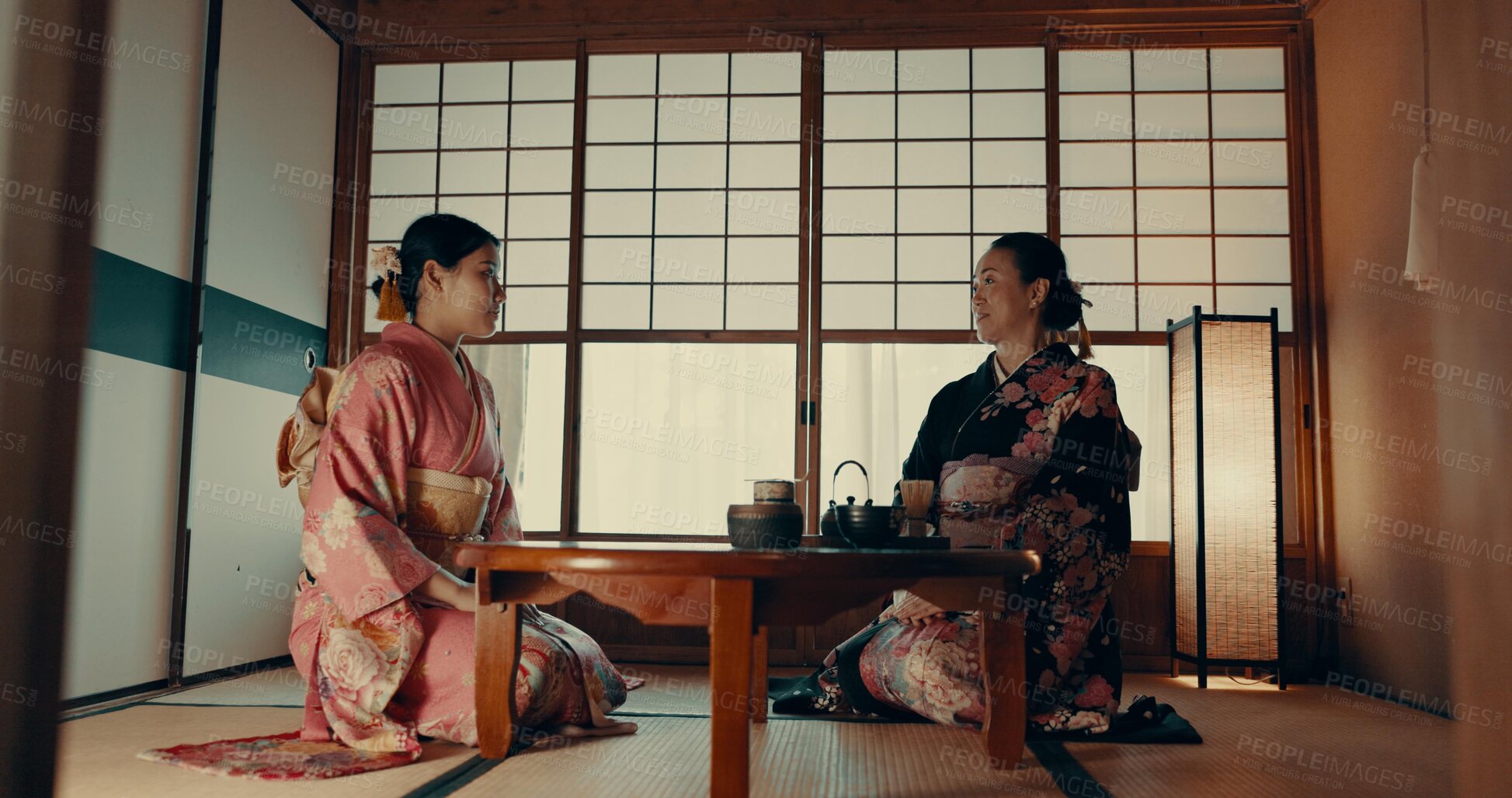 Buy stock photo Women in traditional Japanese tea house, kimono and relax with conversation, respect and service. Friends at calm tearoom together with matcha drink, zen culture and ritual at table for ceremony.