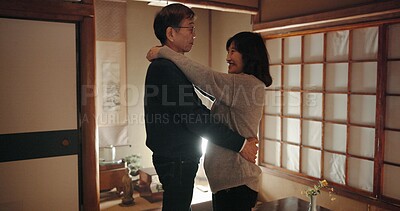 Buy stock photo Mature couple, dancing and home with love, smile and happiness with weekend break, hug and bonding together. Japanese people, man and woman embrace, apartment and cheerful with peace and support