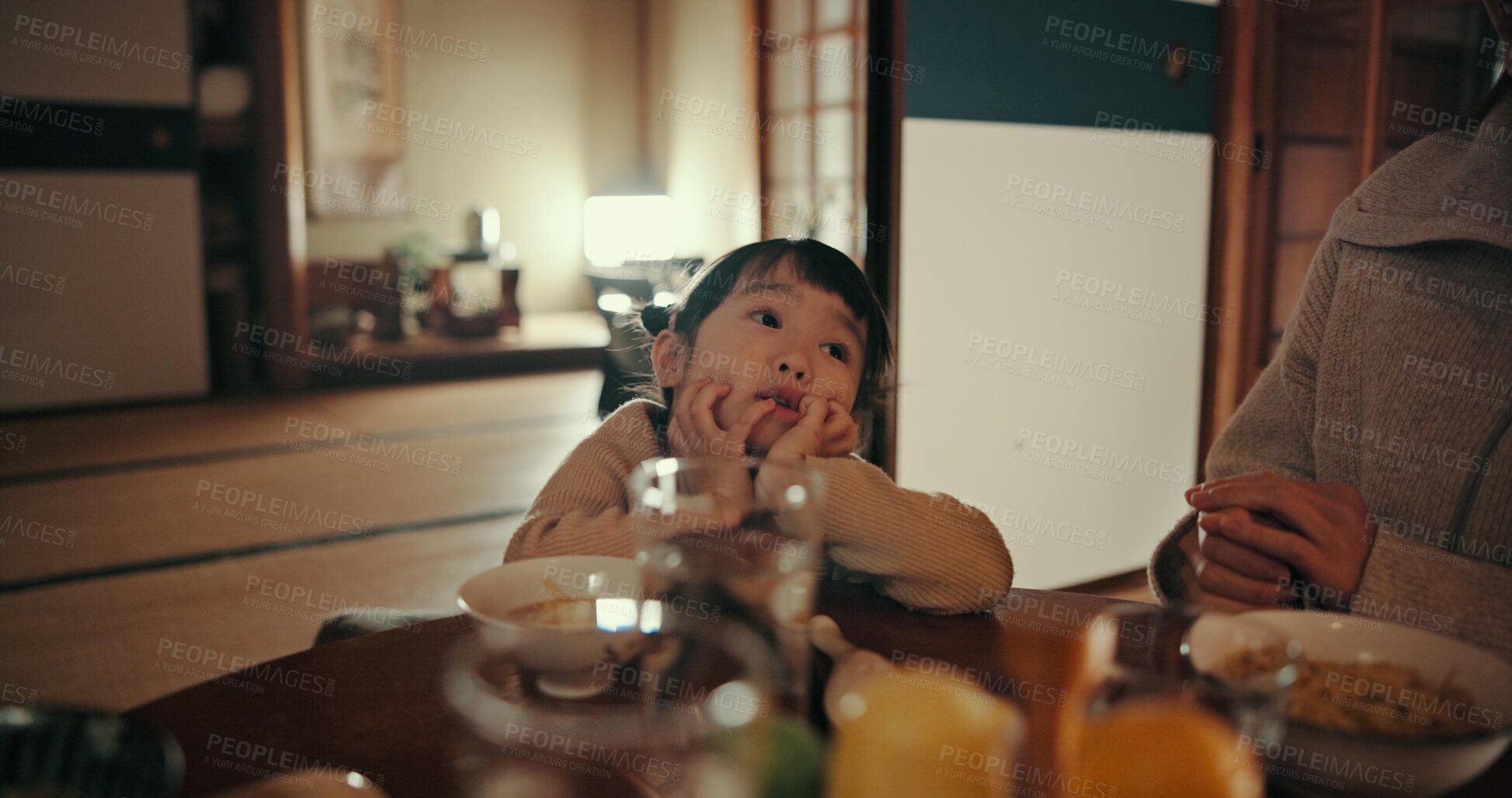 Buy stock photo Asian child, family home and bored at dinner with parents for food, tired or night in dining room. Japanese kid, nutrition and diet with thinking, annoyed or frustrated by table at apartment in Tokyo