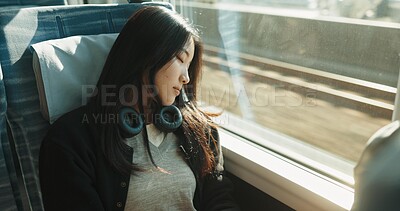 Buy stock photo Japanese woman, sleeping and train with travel, headphones and public transportation on metro bullet. Young person, tired and rest on fast vehicle for weekend trip and commute with audio technology