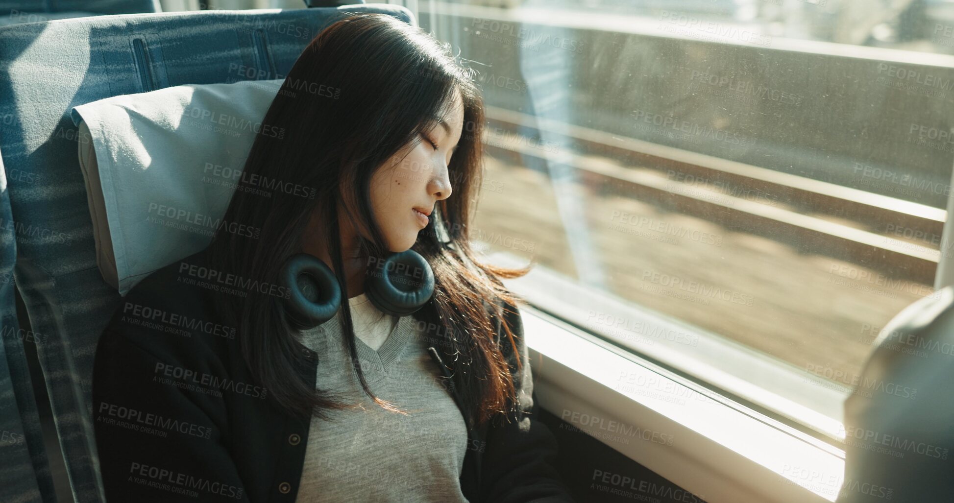 Buy stock photo Japanese woman, sleeping and train with travel, headphones and public transportation on metro bullet. Young person, tired and rest on fast vehicle for weekend trip and commute with audio technology