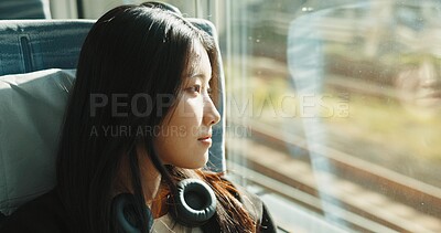 Buy stock photo Japanese woman, window and train with headphones, travel and public transportation on metro bullet. Young person, thinking and relax on fast vehicle for weekend trip and wellness by audio technology