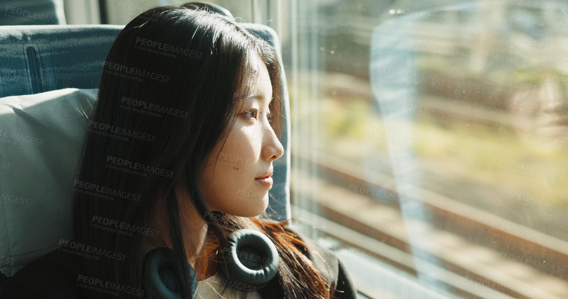 Buy stock photo Japanese woman, window and train with headphones, travel and public transportation on metro bullet. Young person, thinking and relax on fast vehicle for weekend trip and wellness by audio technology