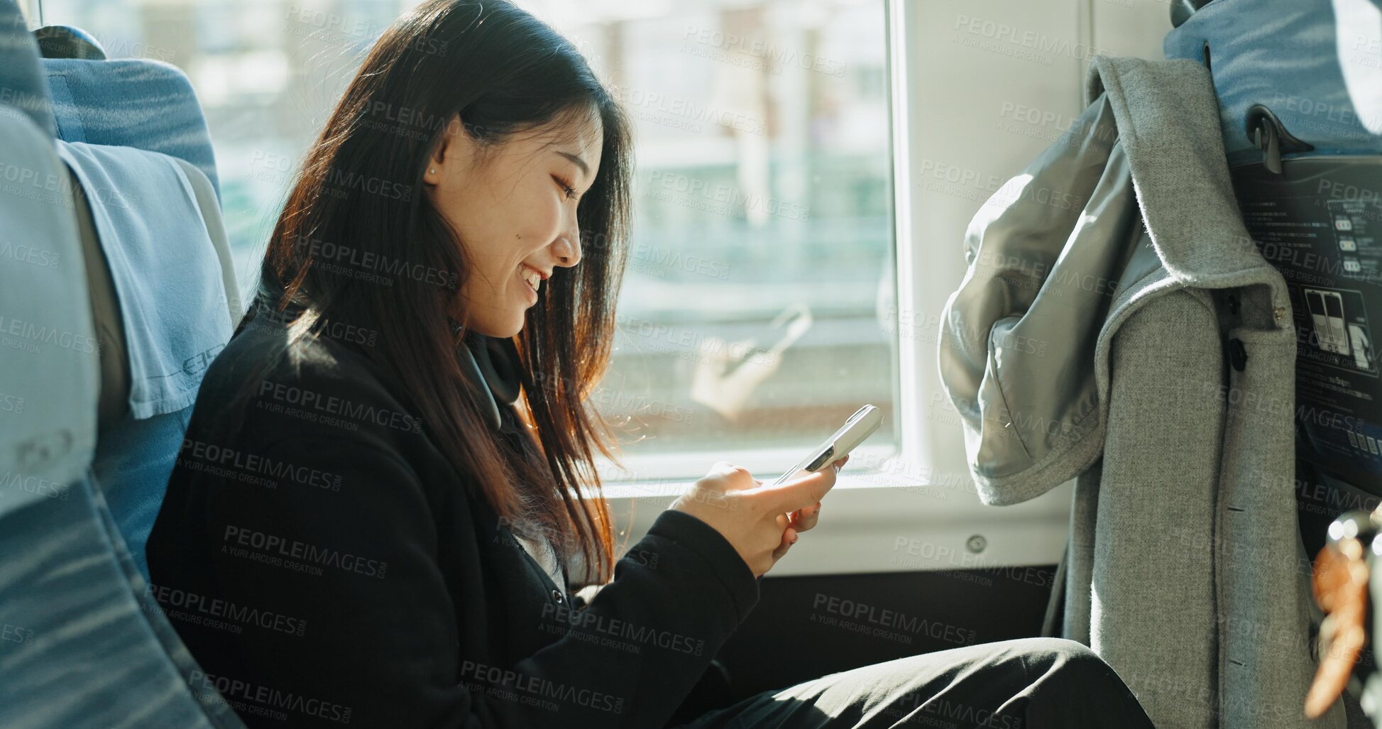 Buy stock photo Bus, travel and woman with a smartphone, smile and Japanese with commute, social media and connection. Person, transportation and girl with cellphone, mobile user and typing with communication or joy