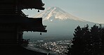 Chureito Pagoda, Mount Fuji and view of city in morning with temple, trees and blue sky on travel. Japanese architecture, culture and spiritual history with mountain, snow and calm Asian landscape.