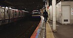 Train, platform and man at station for travel, commute or journey on railway transportation. Public transport, underground railroad service and back of person walking for departure, arrival or subway