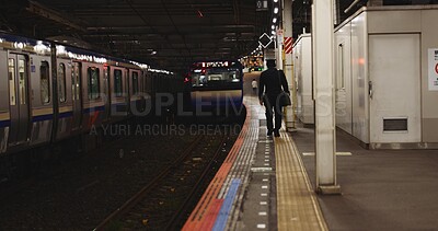 Train, platform and man at station for travel, commute or journey on railway transportation. Public transport, underground railroad service and back of person walking for departure, arrival or subway