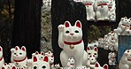 Lucky cat, figure and Shinto shrine in nature, trees and forest with wish, faith or trees in environment. Animal, toys and temple for religion, worship or Buddhism with icon, symbol or wave in Japan