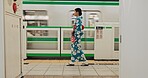 Woman, waiting and travel by train in kimono and public transportation on metro bullet in city. Person, journey and traditional clothes in fast vehicle on weekend and commute in tokyo for adventure