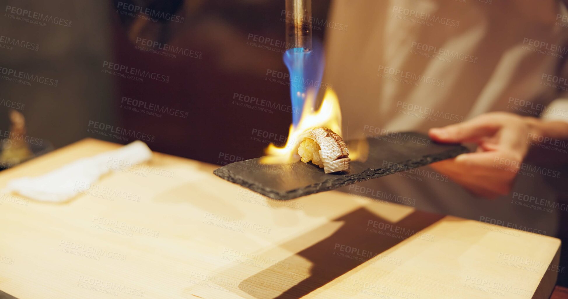 Buy stock photo Hands, fire and cooking sushi with chef in restaurant for traditional Japanese food or cuisine closeup. Kitchen, flame for seafood preparation and person working with gourmet meal recipe ingredients