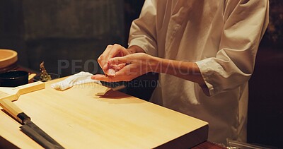 Buy stock photo Hands, food and sushi chef in restaurant for traditional Japanese cuisine or dish closeup. Kitchen, cooking or seafood preparation and person working with fresh gourmet meal recipe ingredients