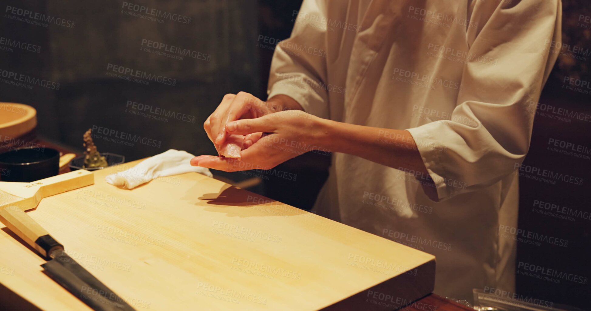 Buy stock photo Hands, food and sushi chef in restaurant for traditional Japanese cuisine or dish closeup. Kitchen, cooking or seafood preparation and person working with fresh gourmet meal recipe ingredients