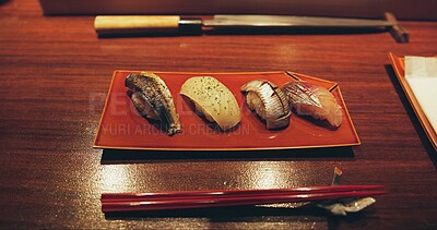 Buy stock photo Table, restaurant and Japanese sushi for fish, raw salmon and healthy food on plate for asian culture. Japan, cuisine and rice for vitamins or nutrition, display and catering with seafood lunch menu