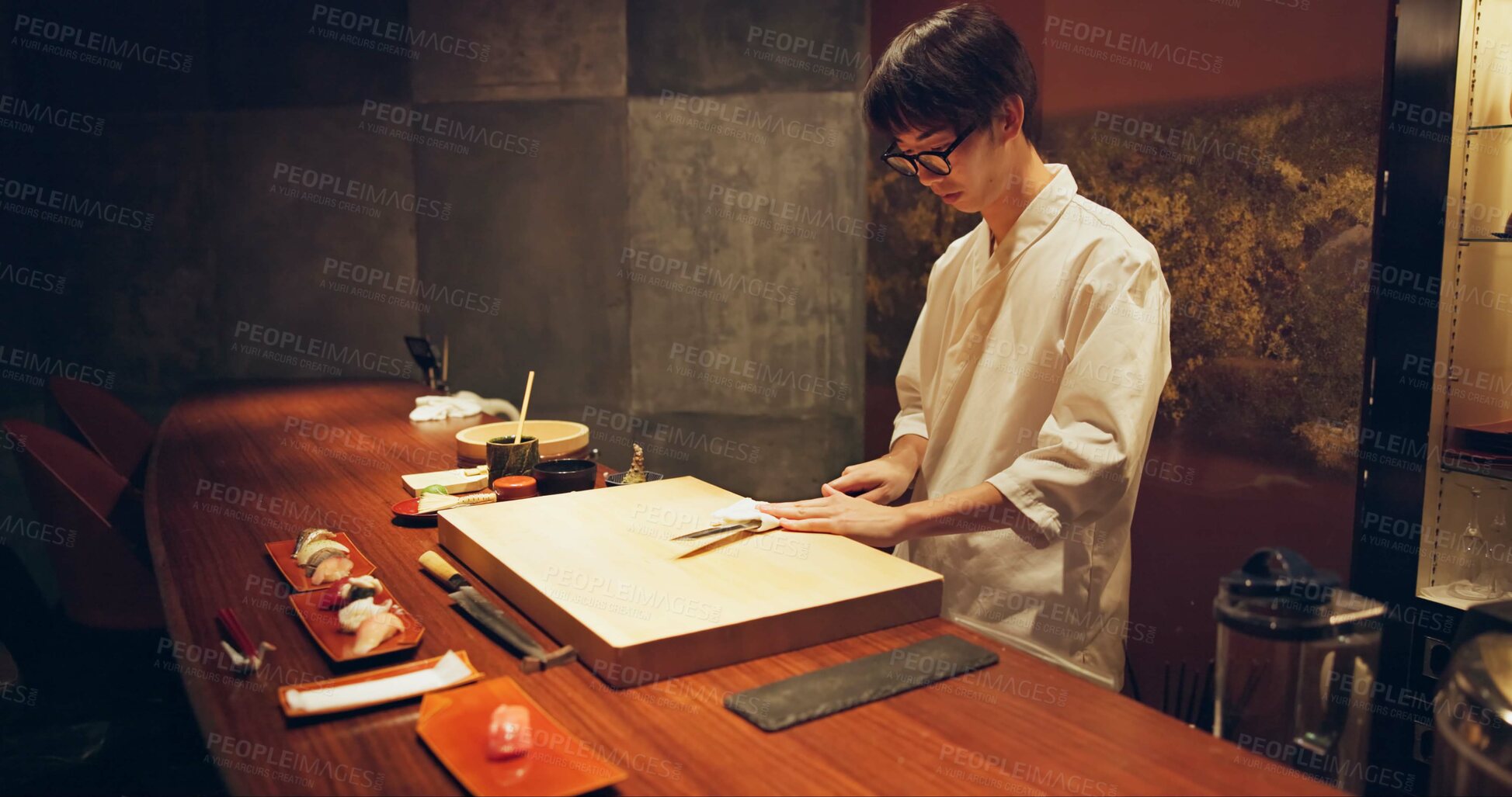 Buy stock photo Japan chef, restaurant and knife for sushi and precision with sharp blade for gourmet fish menu in hotel. Asian man, hands and culinary artist on job by wood board, table and raw seafood on plate