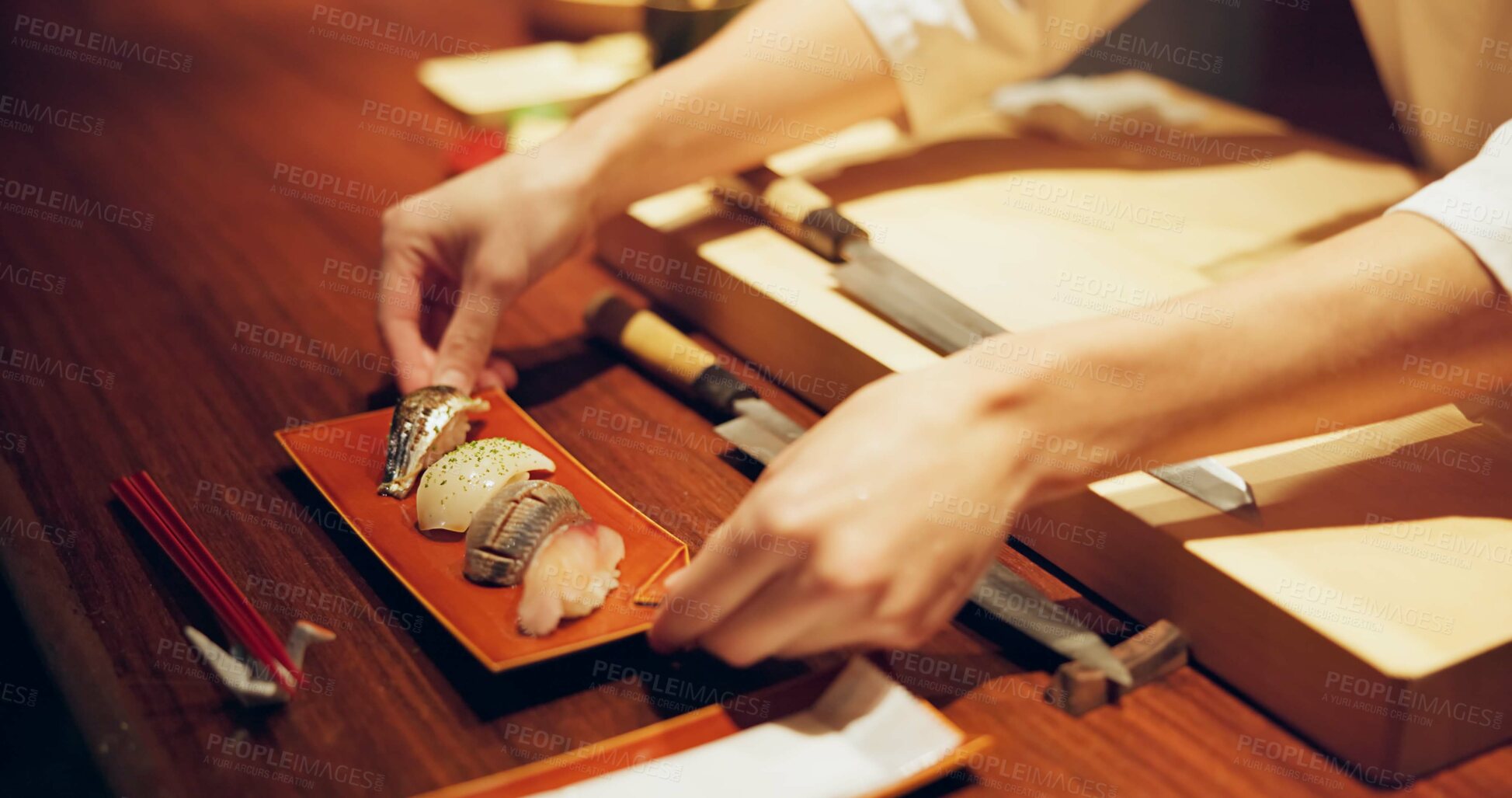 Buy stock photo Hands, cooking and chef serving sushi in restaurant for traditional Japanese cuisine or dish closeup. Kitchen, service or preparation of seafood and person working with gourmet recipe ingredients