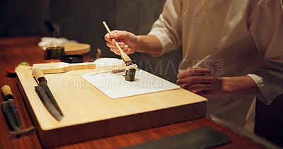 Buy stock photo Hands, food and sushi with cook in restaurant for traditional Japanese cuisine or dish closeup. Kitchen, table for seafood preparation and professional chef working with gourmet recipe ingredients