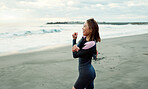 Surfer, beach and woman with stretching, exercise and vacation with getaway trip, workout and training. Person, Japan and girl with ocean, waves and fitness with warm up, muscle and wellness