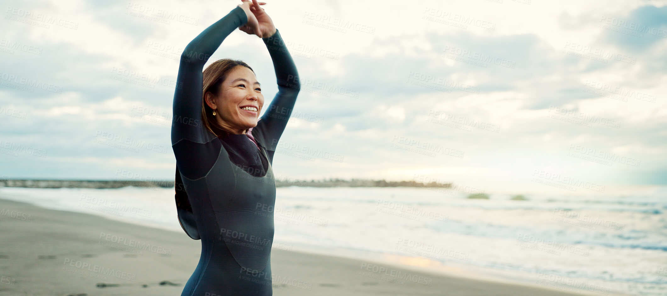 Buy stock photo Surfer, Japanese and woman stretching at beach, happy for fitness and extreme sports with ocean view, waves and travel. Flexibility, warm up and exercise outdoor, surf and nature with smile in Japan