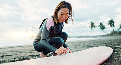 Buy stock photo Surfing, beach and woman waxing surfboard for water sports, fitness and freedom by ocean. Nature, travel and happy Japanese person on sand for wellness on holiday, vacation and adventure by sea