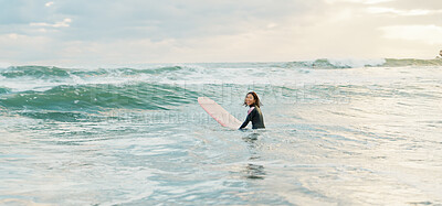 Surfing, beach and woman with waves on surfboard for water sports, fitness and freedom by ocean. Nature, travel and happy Japanese person for training on holiday, vacation and adventure by sea