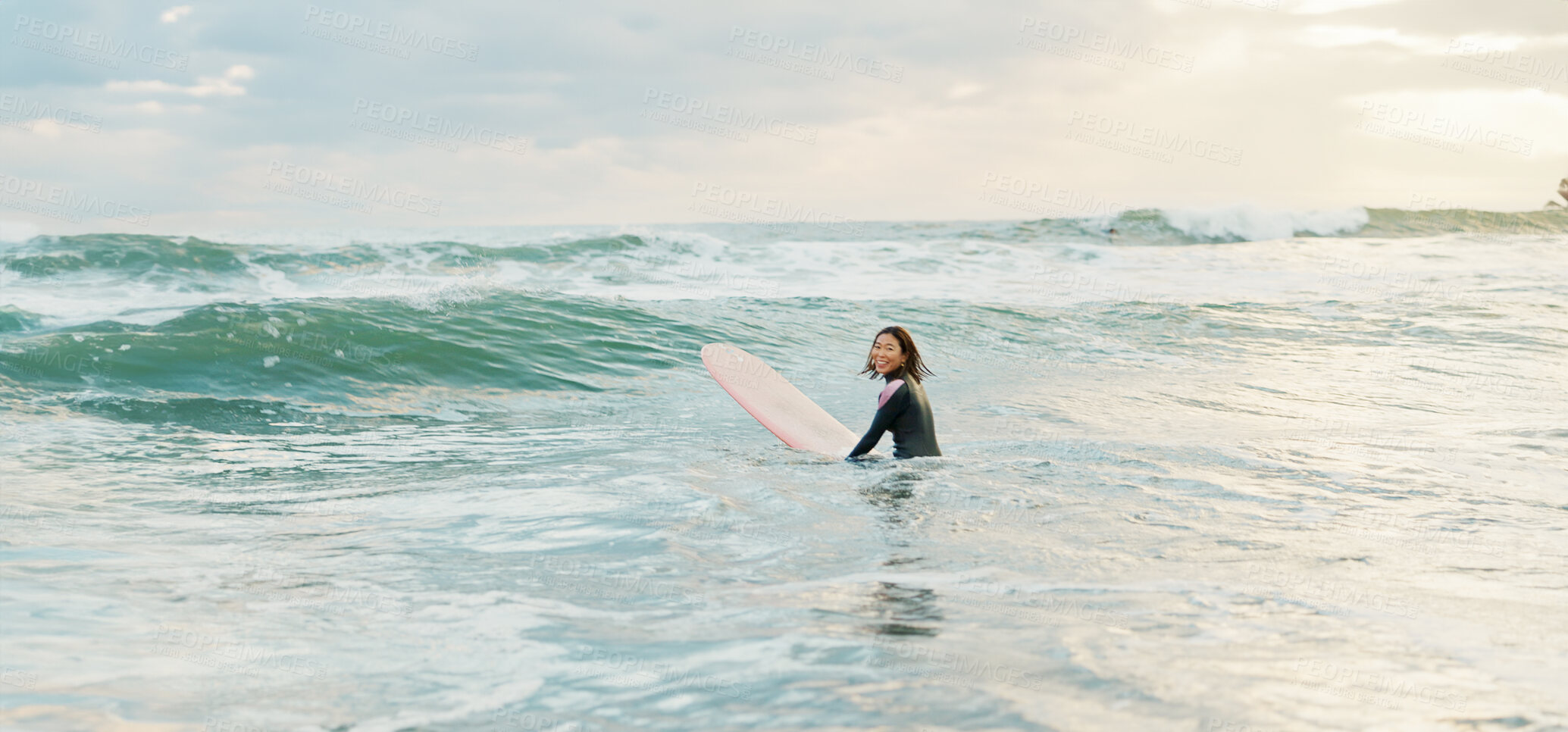 Buy stock photo Surfing, beach and woman with waves on surfboard for water sports, fitness and freedom by ocean. Nature, travel and happy Japanese person for training on holiday, vacation and adventure by sea