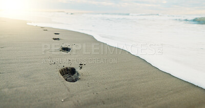 Footprints, sea and sand with beach and nature, environment and tropical landscape with travel. Adventure, journey and sunshine with closeup of ocean, waves with destination for vacation and outdoor