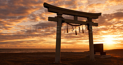 Buy stock photo Torii gate, sunset sky in Japan with clouds, zen and spiritual history on travel adventure. Shinto architecture, Asian culture and calm nature on Japanese landscape with sacred monument at shrine.