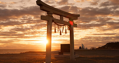 Buy stock photo Torii gate, sunset sky and beach in Japan with clouds, zen and spiritual history on travel adventure. Shinto architecture, Asian culture and calm nature on Japanese landscape with sacred monument.