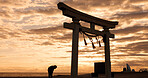 Torii gate, sunset sky in Japan and man in silhouette with clouds, zen and spiritual history on travel adventure. Shinto architecture, Asian night culture and calm nature on Japanese sacred monument.