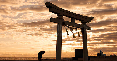 Buy stock photo Torii gate, sunset sky in Japan and man in silhouette with clouds, zen and spiritual history on travel adventure. Shinto architecture, Asian night culture and calm nature on Japanese sacred monument.