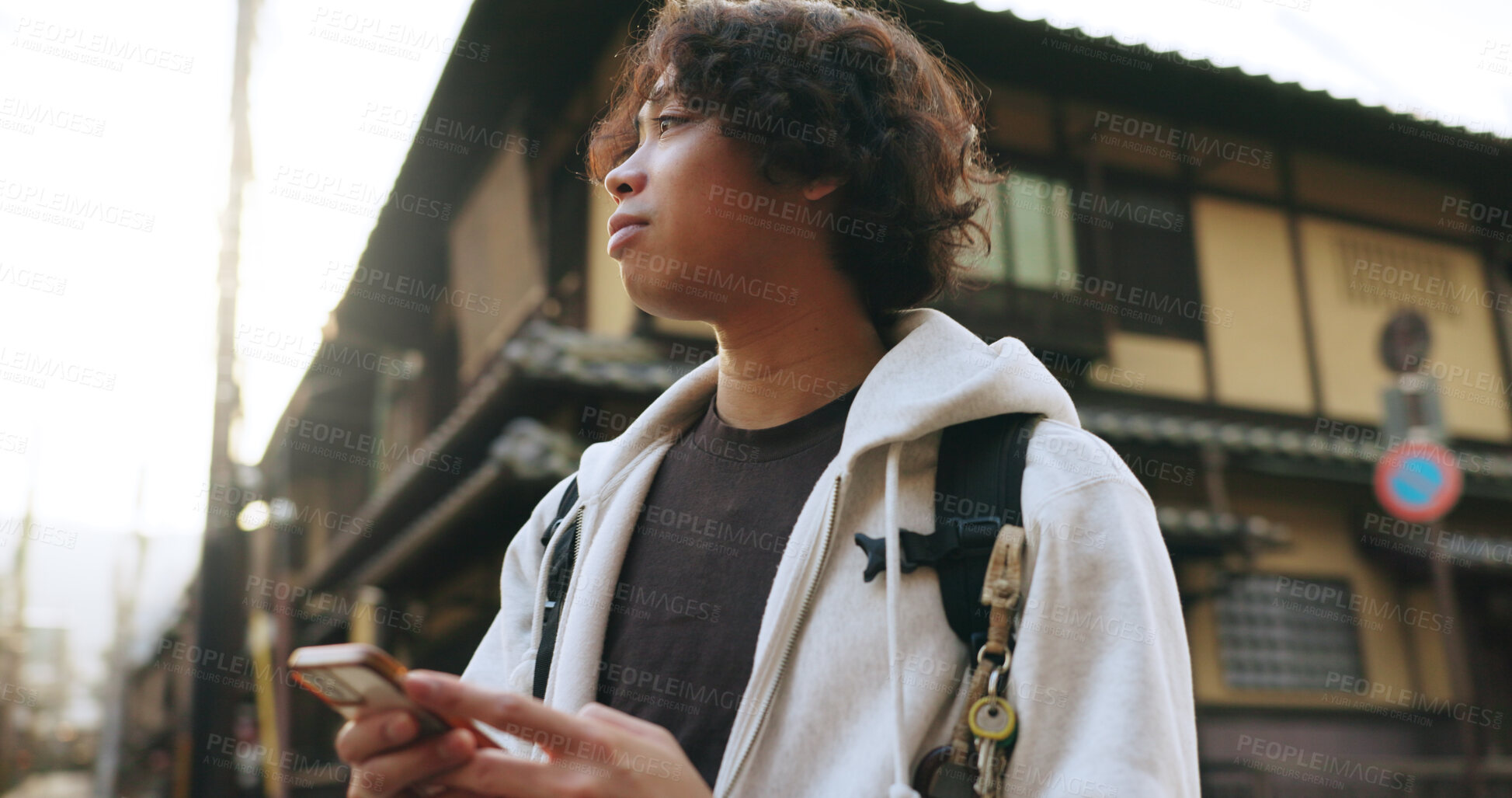 Buy stock photo Japanese man, smartphone and travel in city with technology, gps and connection for destination directions. Young person, cellphone and mobile app in kyoto street and adventure on vacation in summer