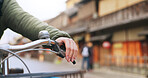 Hands, bicycle and brake handle in street, travel and transport outdoor of active rider on urban road for health. Closeup, press handlebar and person cycling to control or check bike in Kyoto Japan