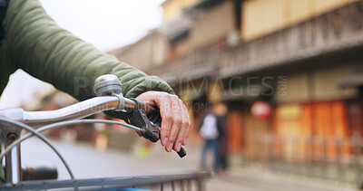 Buy stock photo Hands, bicycle and brake handle in street, travel and transport outdoor of active rider on urban road for health. Closeup, press handlebar and person cycling to control or check bike in Kyoto Japan