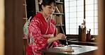 Ink, writing and traditional Japanese woman in home for script on paper, documents and page. Creative, Asian culture and person with vintage paintbrush tools for calligraphy, font and text in house