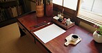 Ink, paint brush and Japanese art with paper on a desk in a home studio with illustration tools. Creative, painter paper and artist with sketch document and calligraphy with pencil and drawing