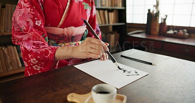 Buy stock photo Hands, writing and Japanese woman for traditional script on paper, documents and letters in home. Creative, Asian culture and person with paintbrush tools for calligraphy, font and text in house