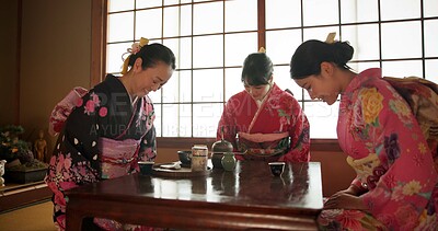 Buy stock photo Japanese, women and bow for tea ceremony in Chashitsu room with kimono dress or custom tradition. People, temae and vintage style outfit or matcha for culture, fashion and happy with antique crockery