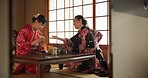 Traditional, culture and Japanese women with tea in home with herbs, leaves and flavor in teapot. Ritual, indigenous and people with herbal beverage for ceremony, talking and wellness for drinking