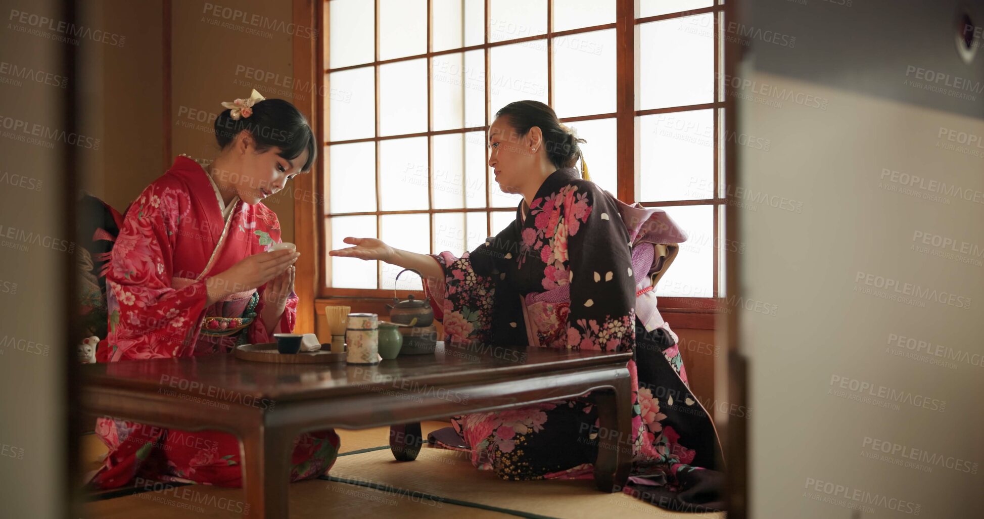 Buy stock photo Traditional, culture and Japanese women with tea in home with herbs, leaves and flavor in teapot. Ritual, indigenous and people with herbal beverage for ceremony, talking and wellness for drinking