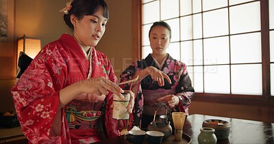 Buy stock photo Culture, teapot and Japanese women with tea in home with traditional herbs, leaves and flavor in home. Ritual, indigenous and people with herbal beverage for ceremony, calm and wellness for drinking