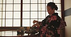 Tea, Japanese woman and traditional with a teapot, flavor and drinking ritual with herbal beverage and leaves. Asian person with culture and ceremony with Kimono, home and calming with wellness