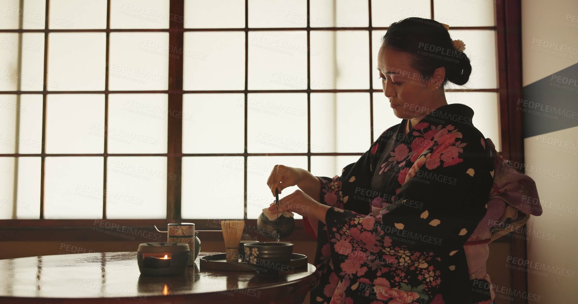 Buy stock photo Tea, Japanese woman and traditional with a teapot, flavor and drinking ritual with herbal beverage and leaves. Asian person with culture and ceremony with Kimono, home and calming with wellness