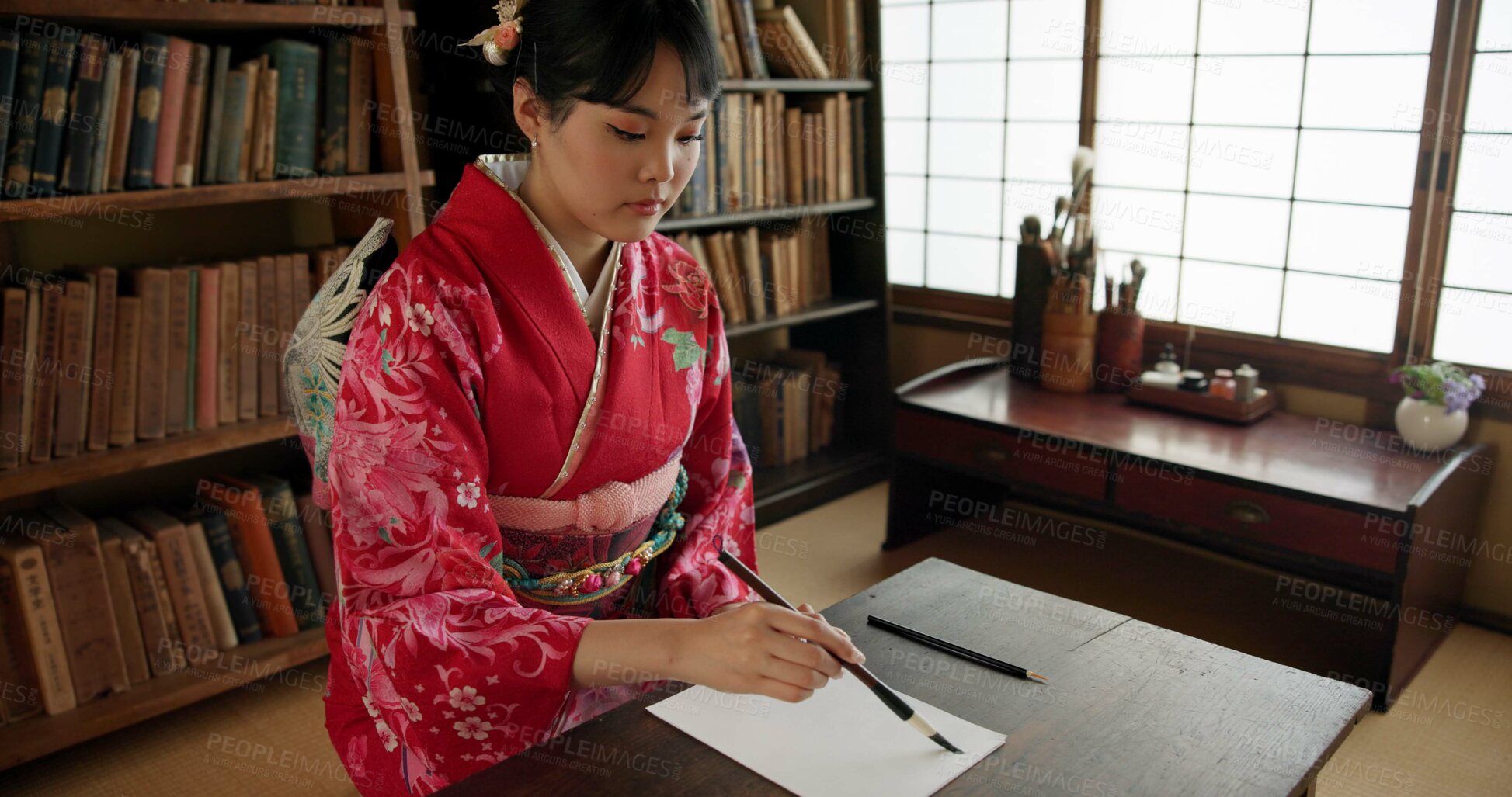 Buy stock photo Ink, writing and Japanese woman in home for traditional script on paper, documents and page. Creative, Asian culture and person with vintage paintbrush tools for calligraphy, font and text in house